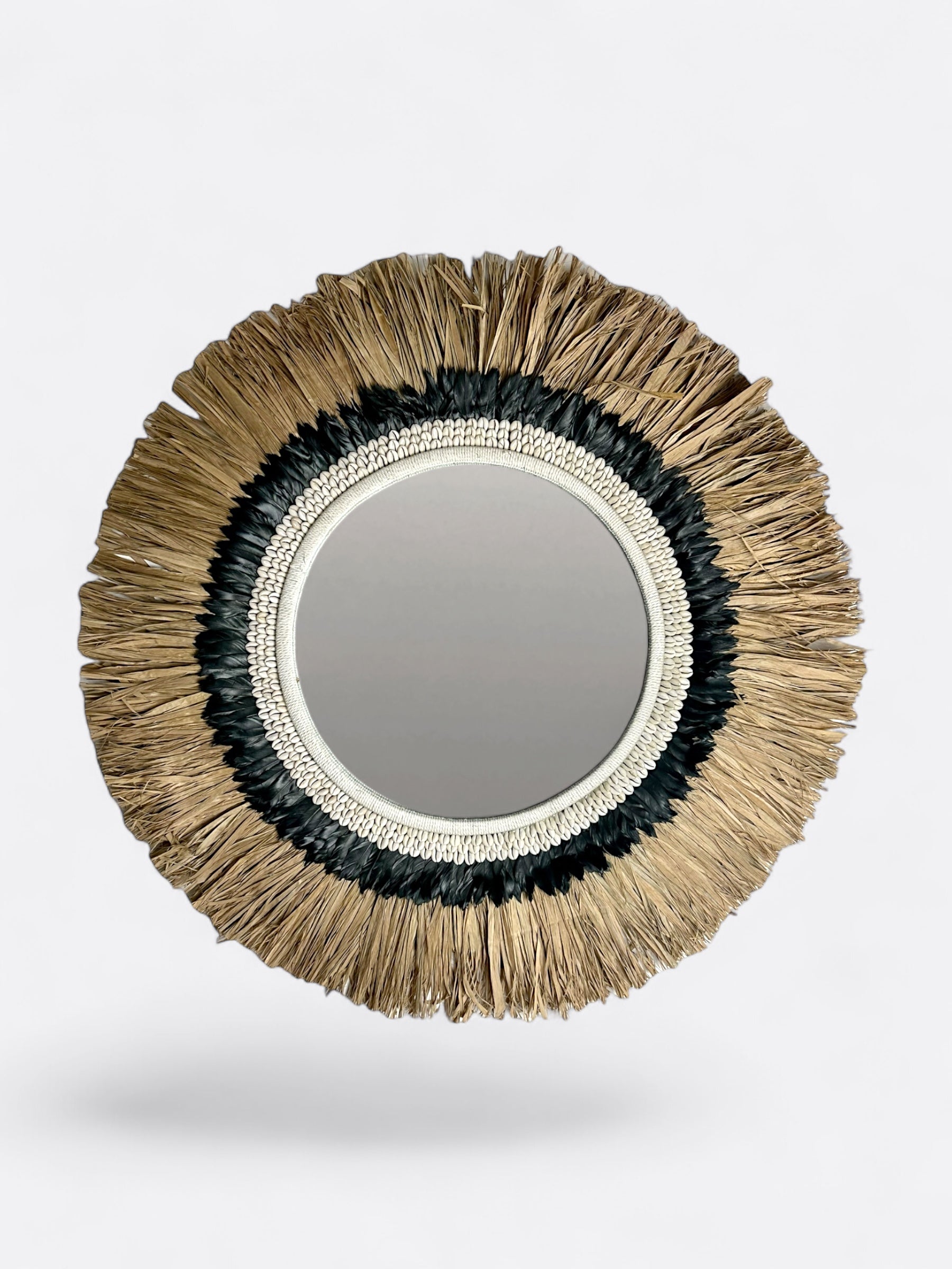 Miroir rond artisanal en raphia avec plume noire et coquillages de Bali