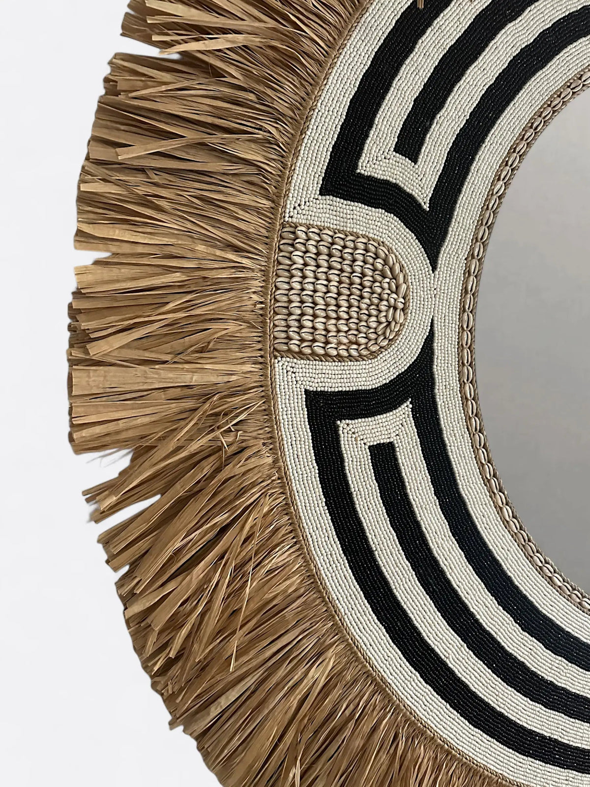 Détail de l'incrustation des perles sur le cadre noir texturé du miroir Grace