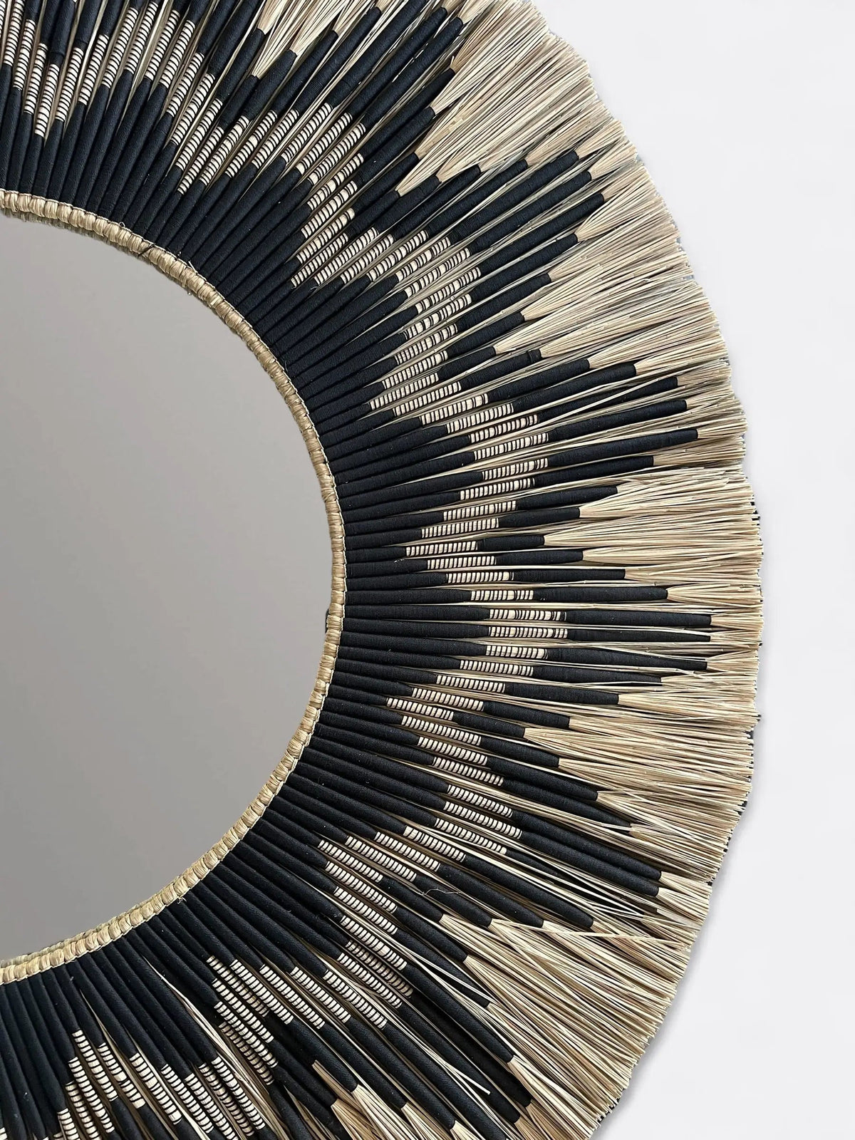 Gros plan sur le tressage en roseau naturel du grand miroir artisanal Rahayu