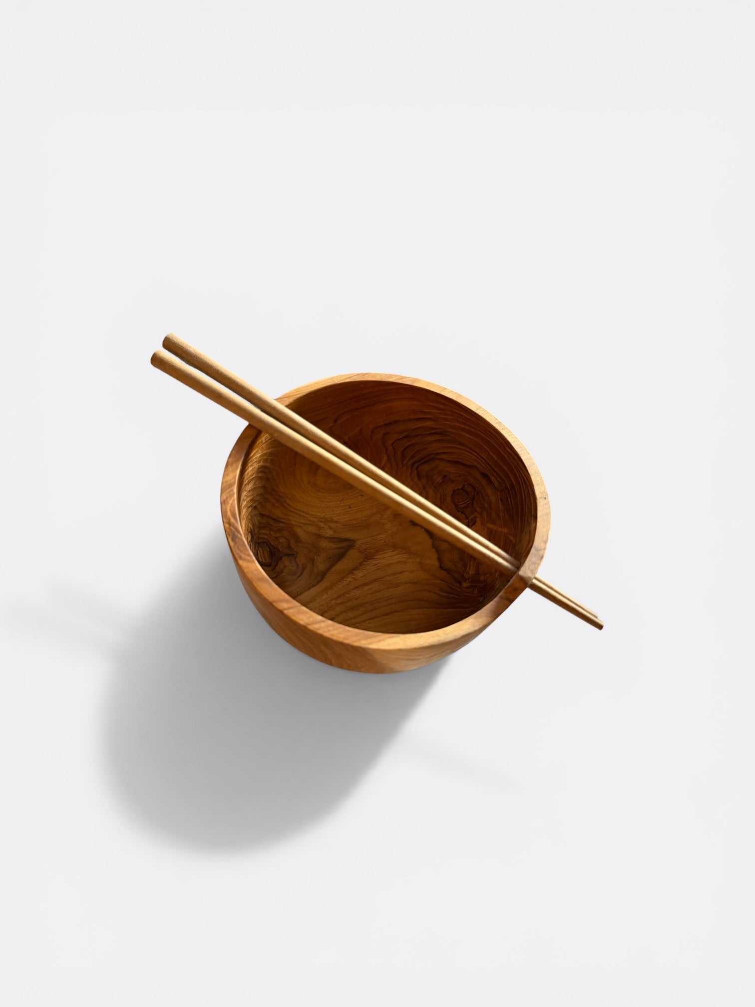 Bols en teck avec baguettes garnis pour un repas asiatique