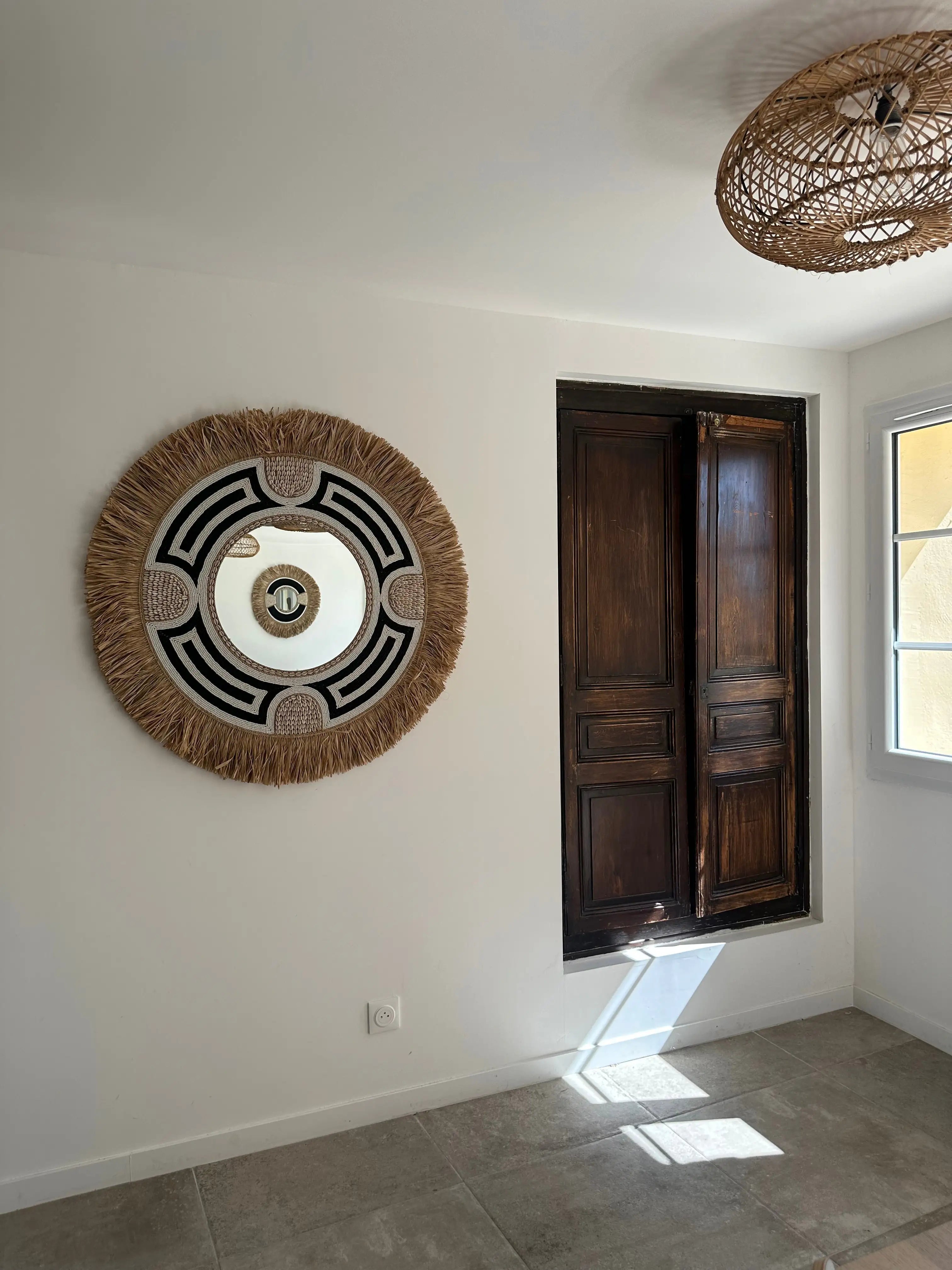 Miroir rond artisanal balinais noir et blanc en coquillages et perles pour décoration intérieure